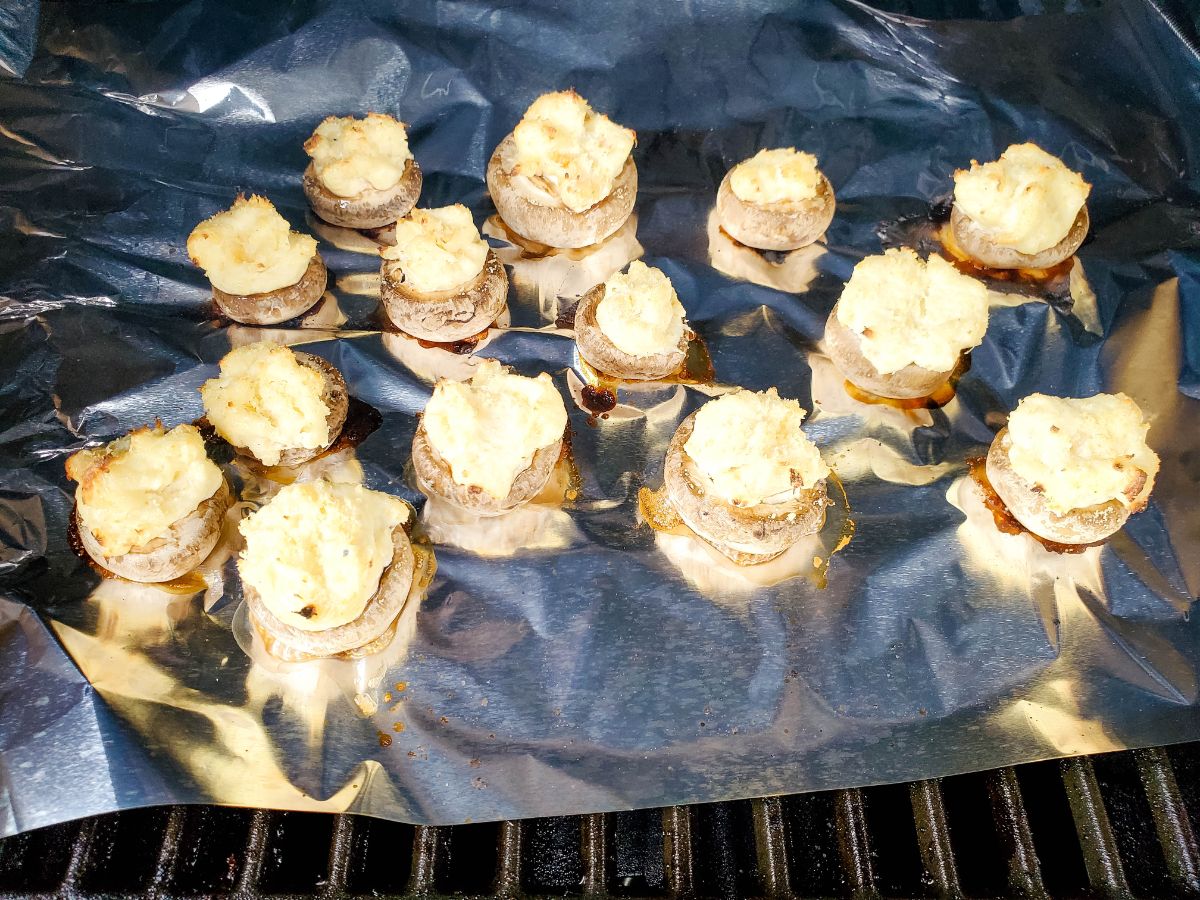 Stuffed Mushrooms with Cream Cheese on a sheet of aluminum foil on a grill