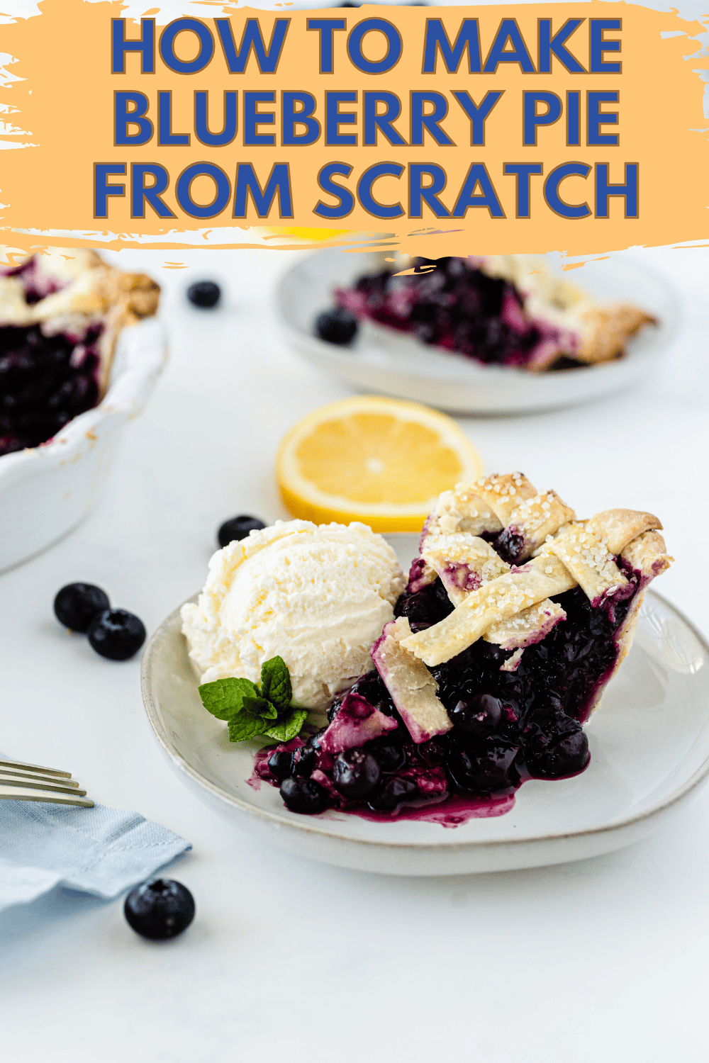  a slice of fresh blueberry pie next to a scoop of vanilla ice cream on a glass plate next to blueberries and a slice of lemon