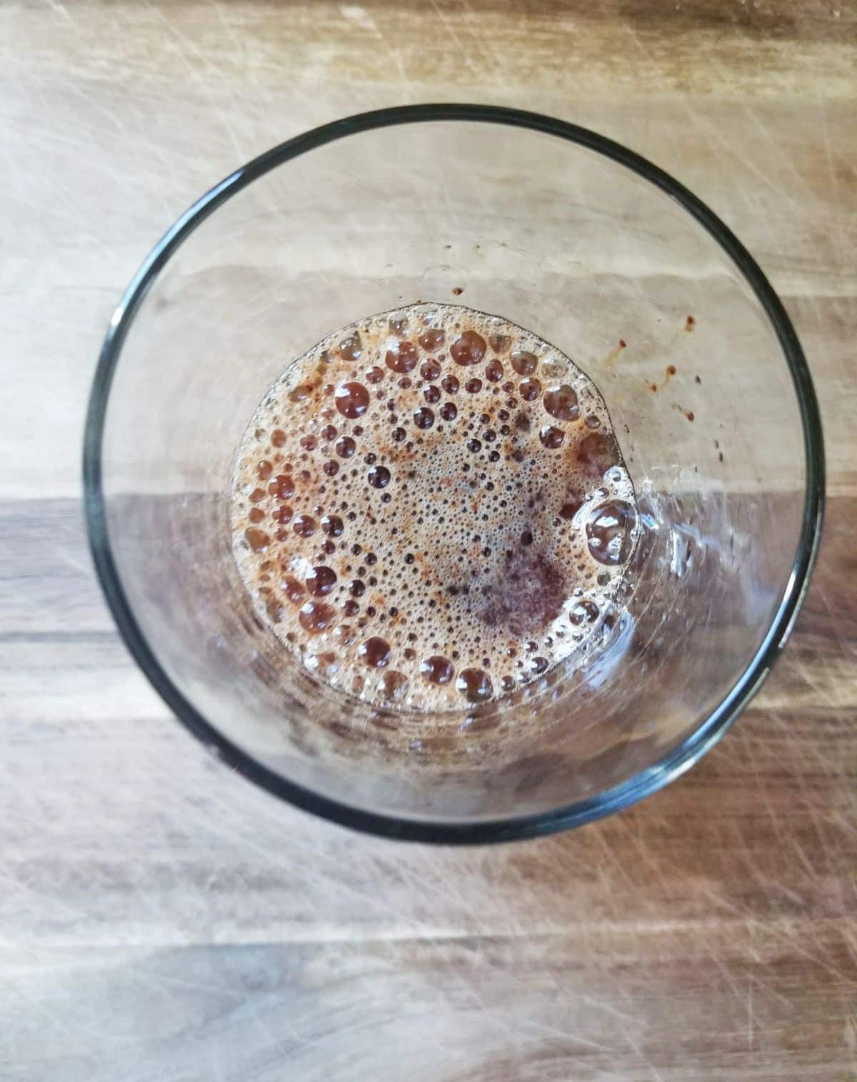 instant coffee and water mixed together in a glass