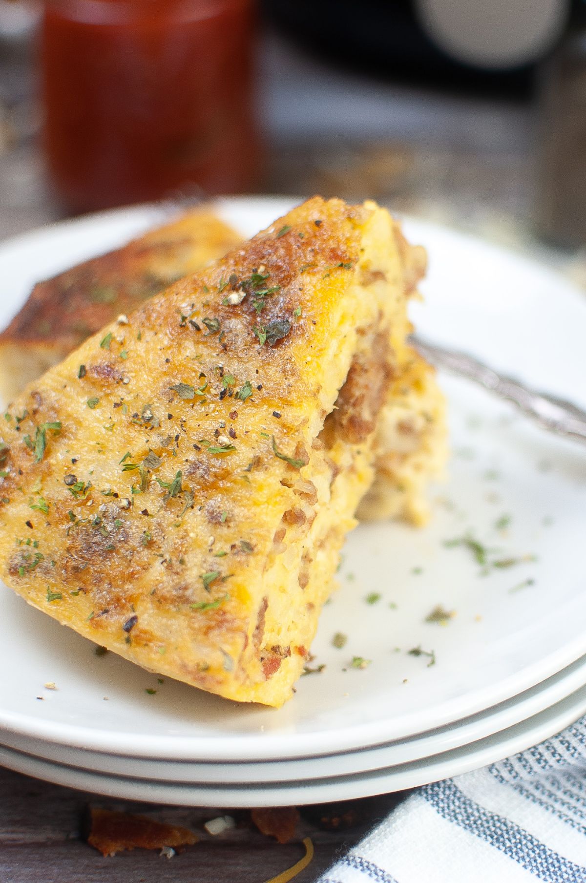 a closeup of Air Fryer Breakfast Casserole on a plate garnished with parsley.