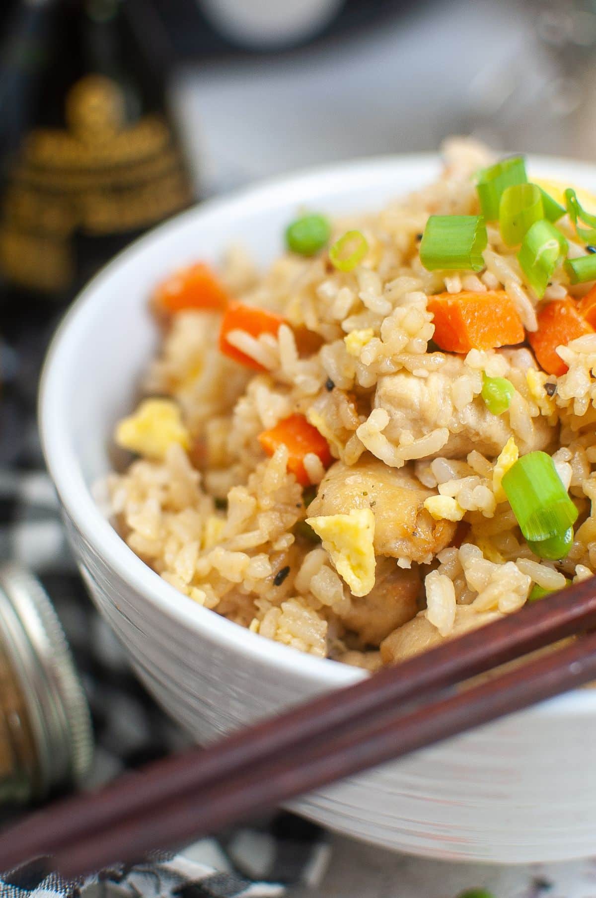 Air Fryer Chicken Fried Rice in a serving bowl with chopsticks on the side. 