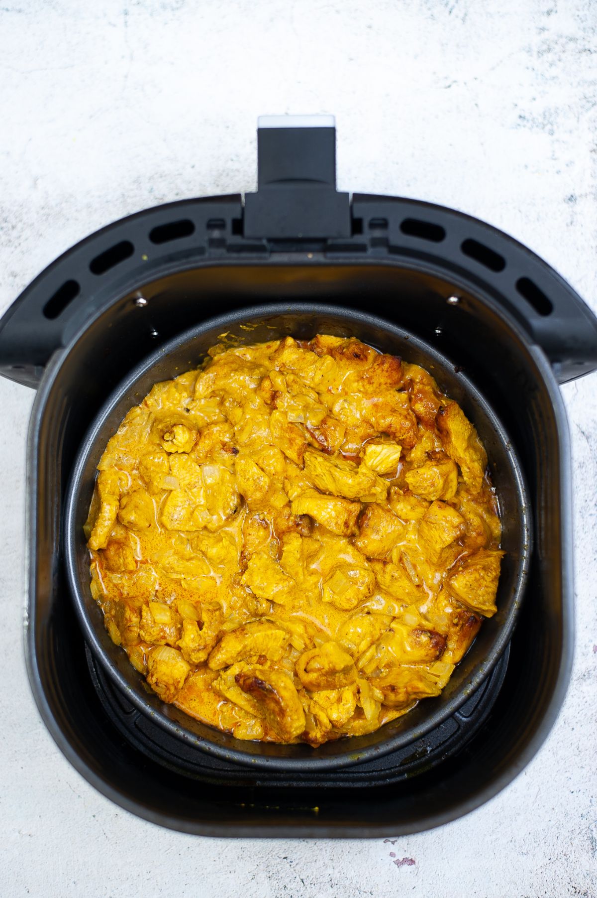 curry chicken mixture in the pan in the air fryer.