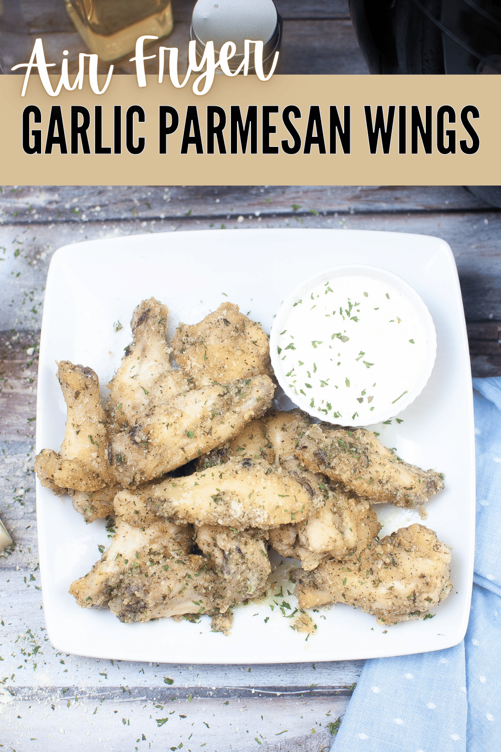 Air Fryer Garlic Parmesan Wings on a plate with dipping sauce on the side with title text reading Air Fryer Garlic Parmesan Wings