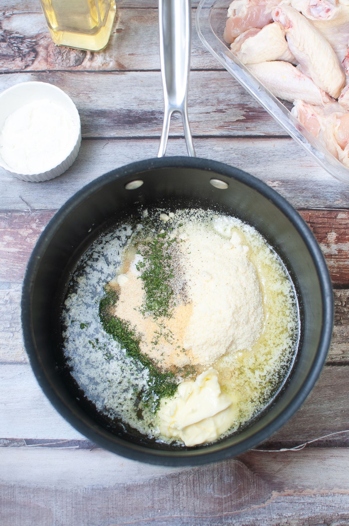 Oil, butter, parmesan cheese, and spices in a medium saucepan.