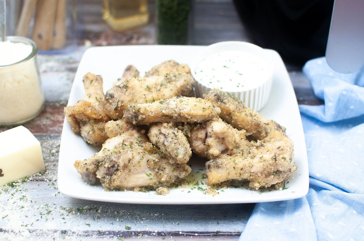 Air Fryer Garlic Parmesan Wings on a plate with dipping sauce on the side