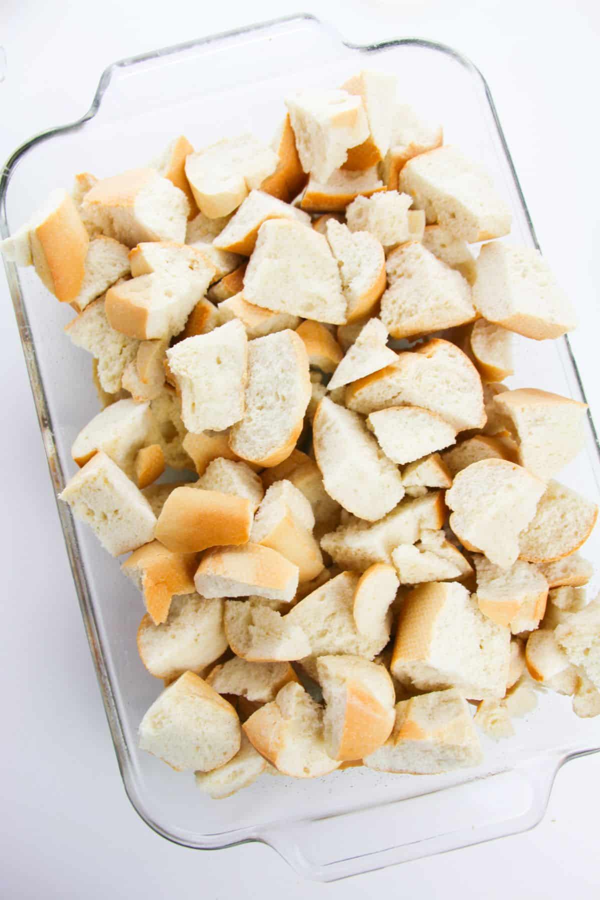 Bread cubes in a glass baking dish.