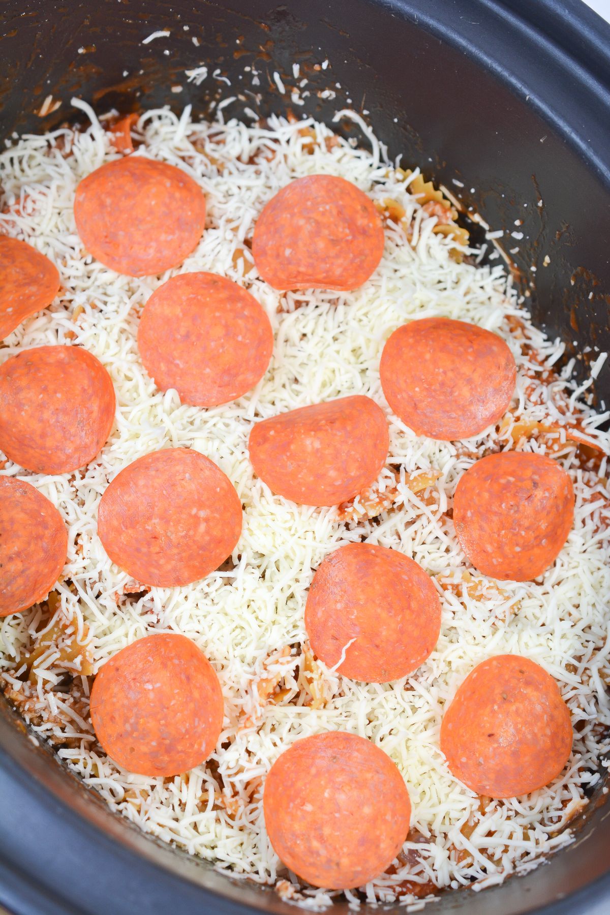 Pizza Casserole mixture topped with the remaining cheese and pepperoni.