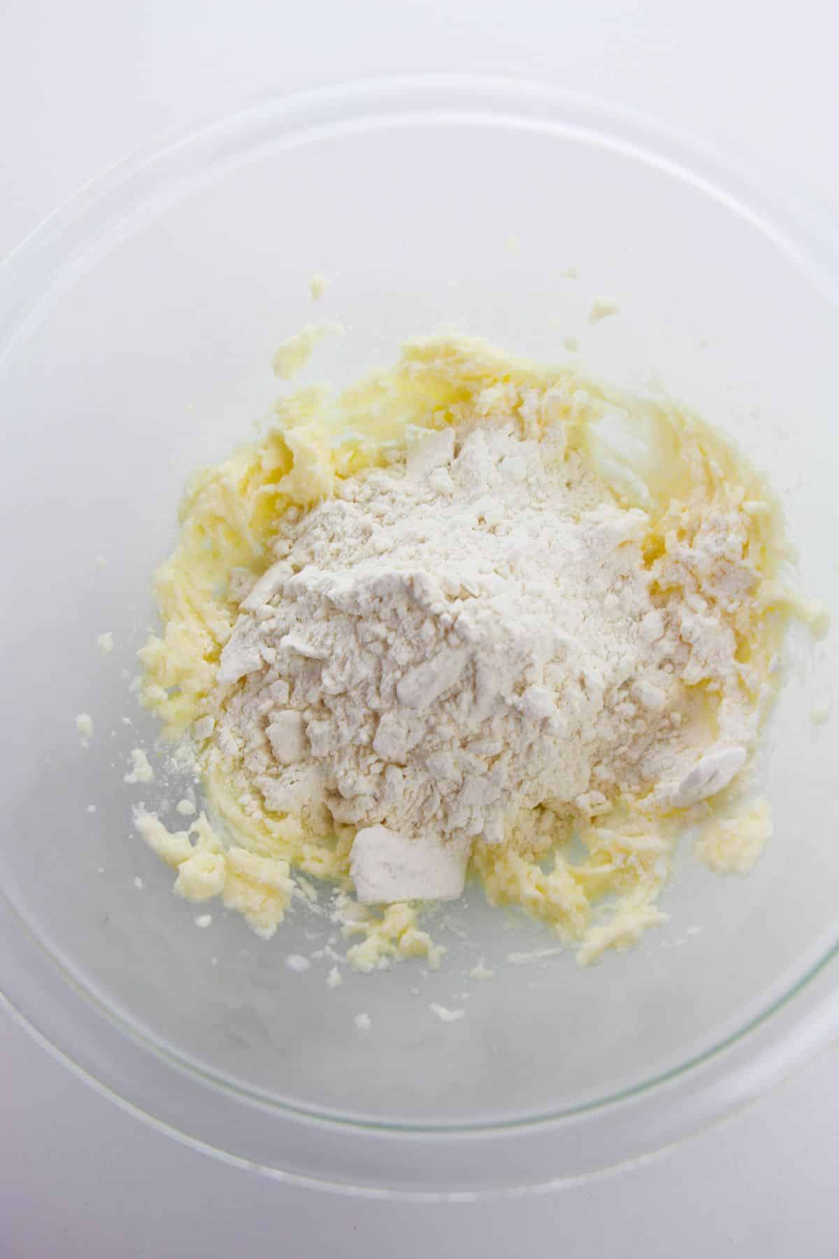 the dry ingredients added into the batter in the glass mixing bowl.