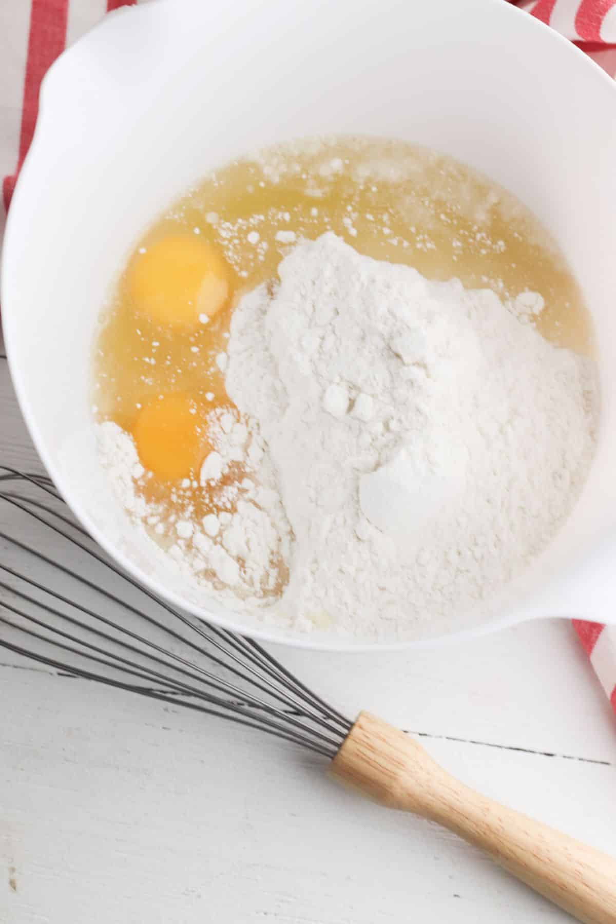 Cake mix, eggs, and vegetable oil in a mixing bowl.