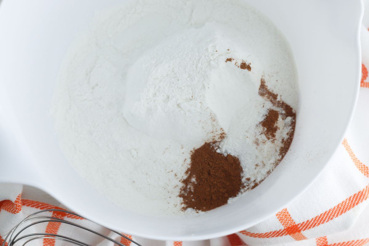 Cake mix and pumpkin pie spice in a mixing bowl