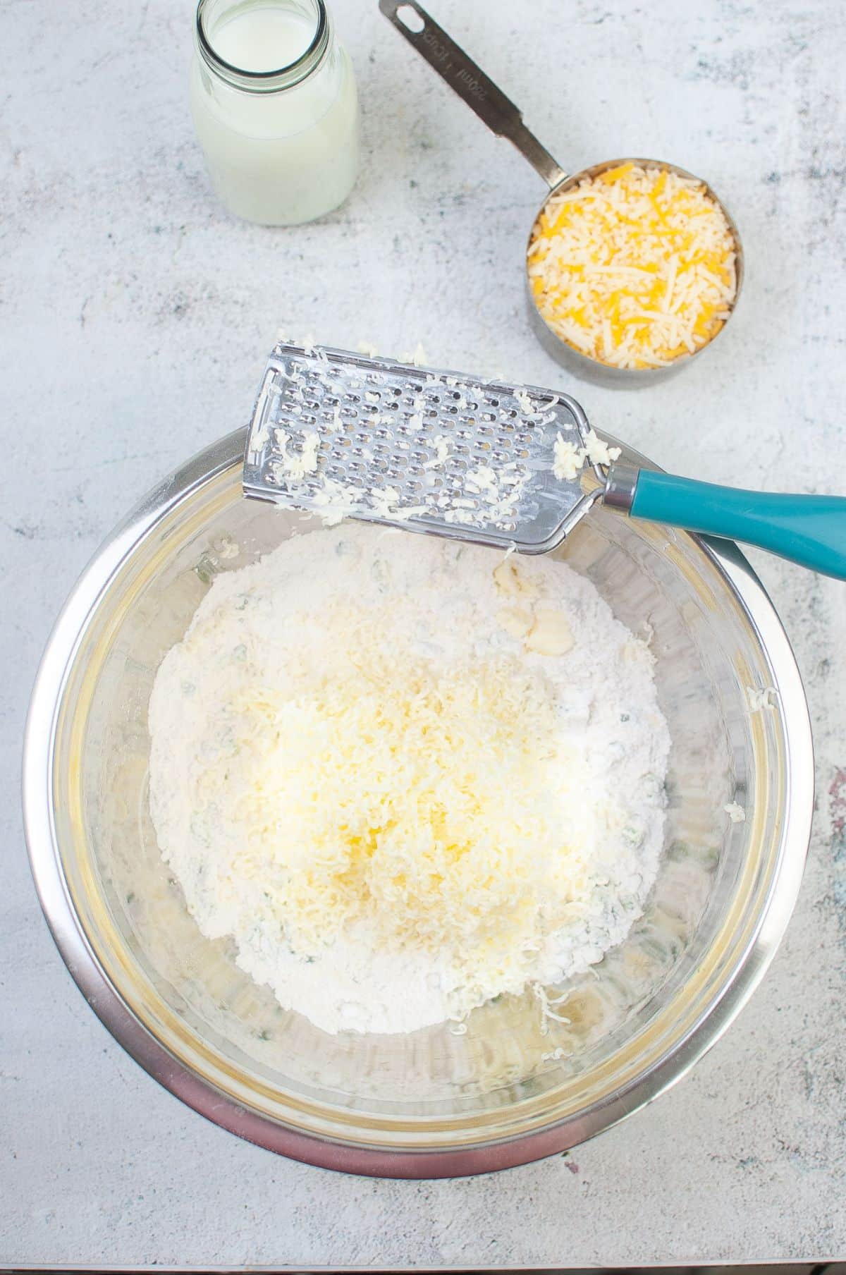 The grated butter is added to the flour mixture.