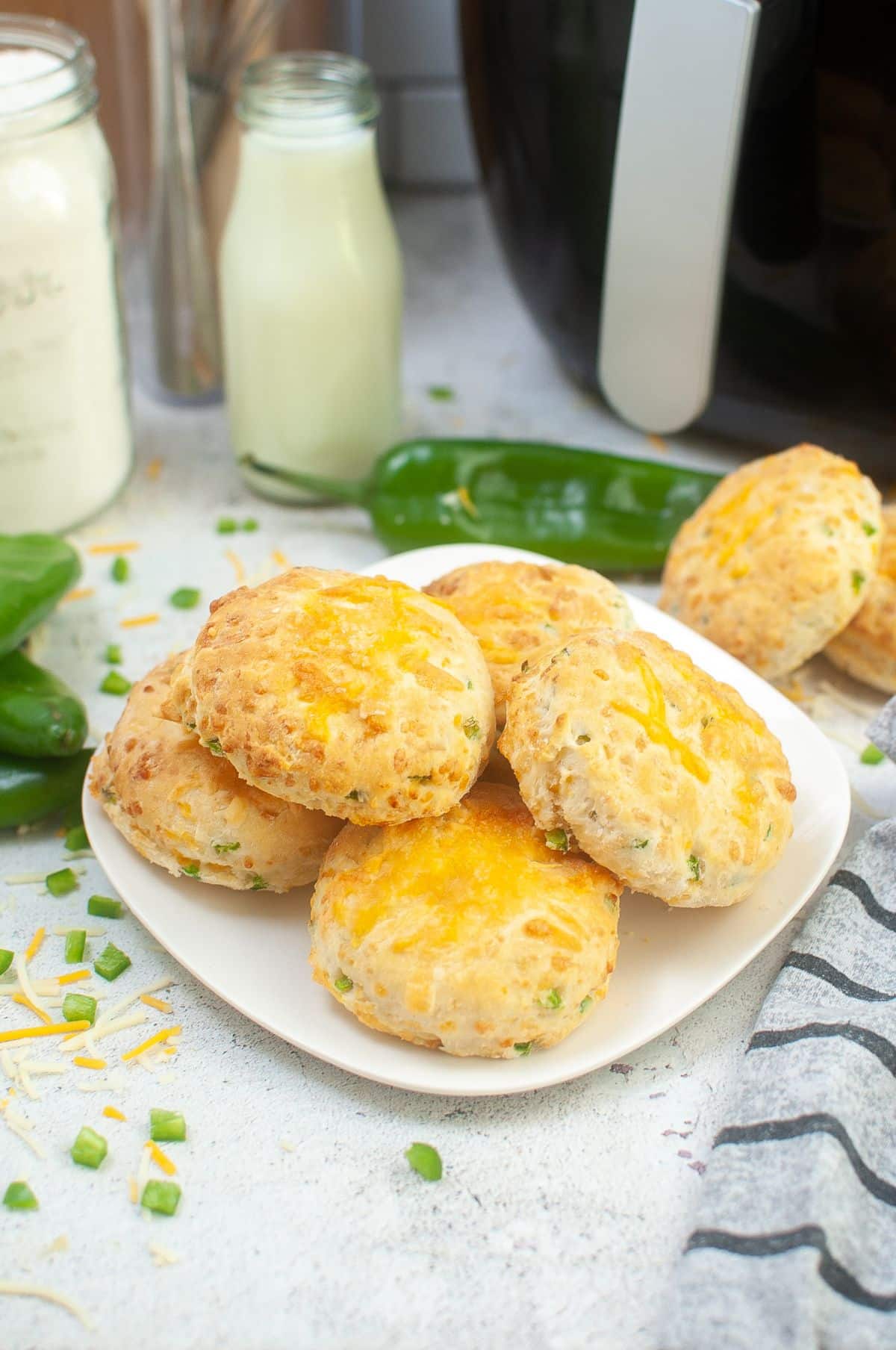 Air Fryer Biscuits on a serving plate, with Hatch Chilies and cheese on the side.