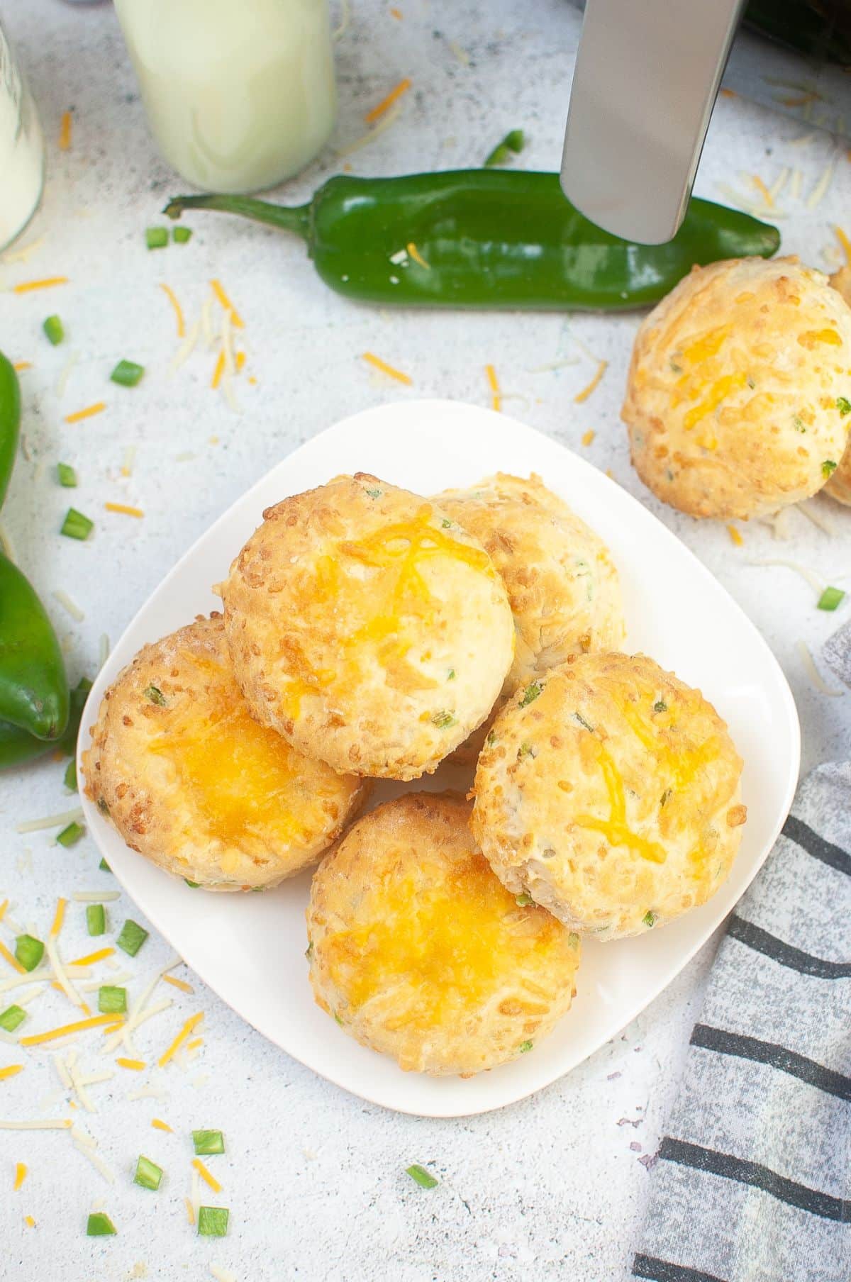 Air Fryer Biscuits on a serving plate, with Hatch Chilies and cheese on the side.