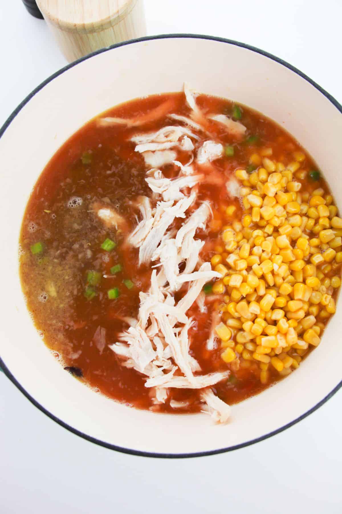 The chicken, corn, black beans, and seasonings are added to the soup mixture.