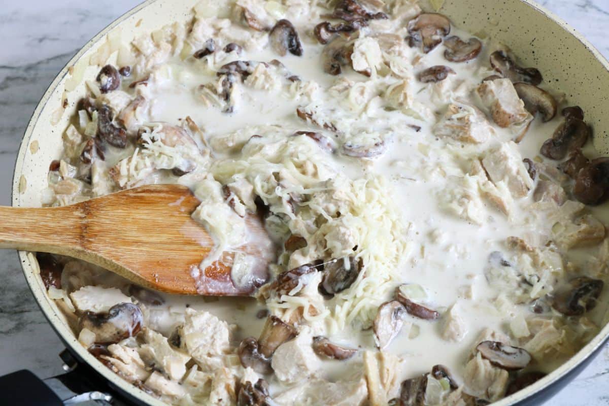 heavy cream, cheese, onion, mushrooms, and garlic in a skillet.