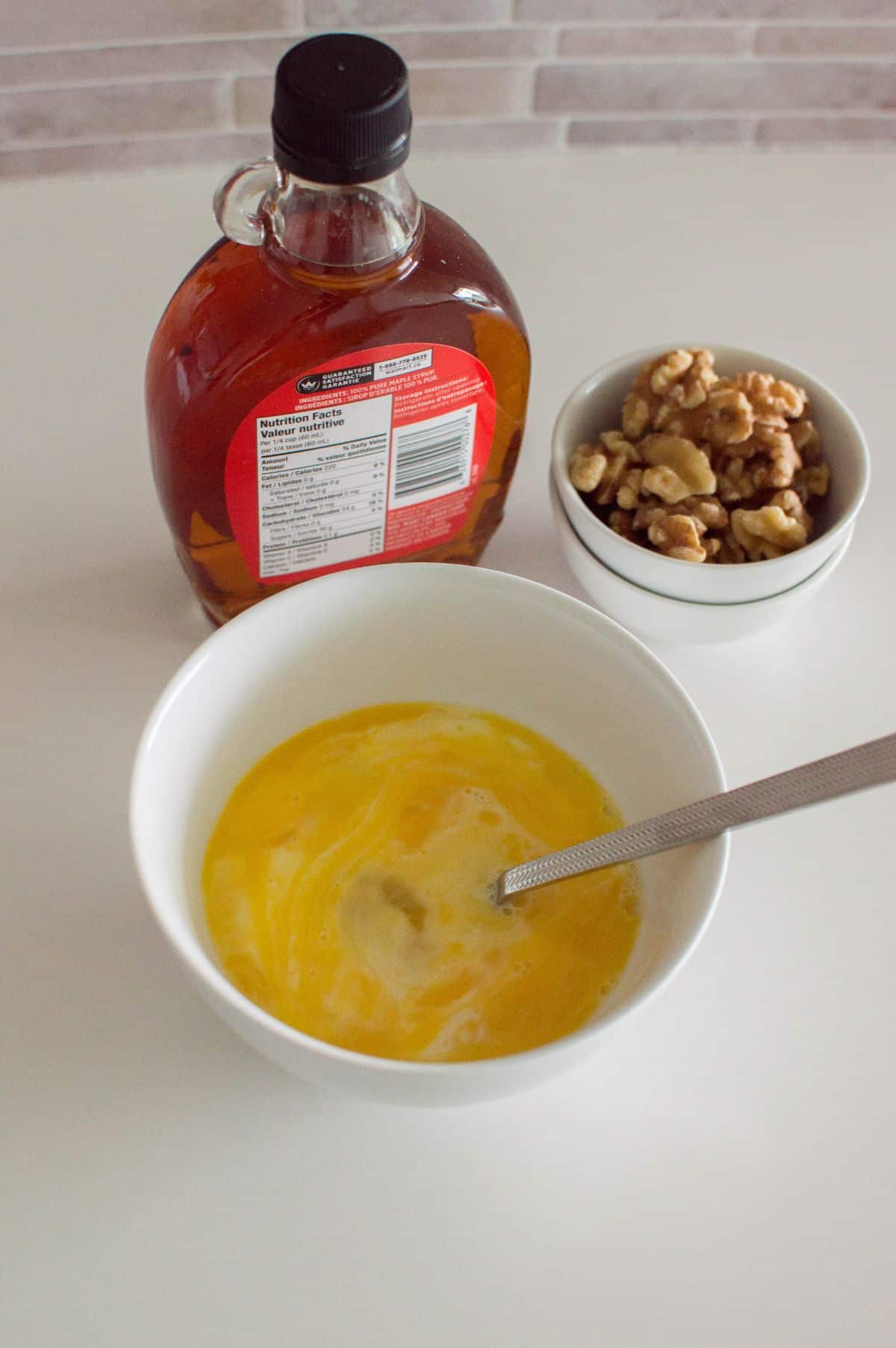 eggs, milk and maple syrup in a small mixing bowl.