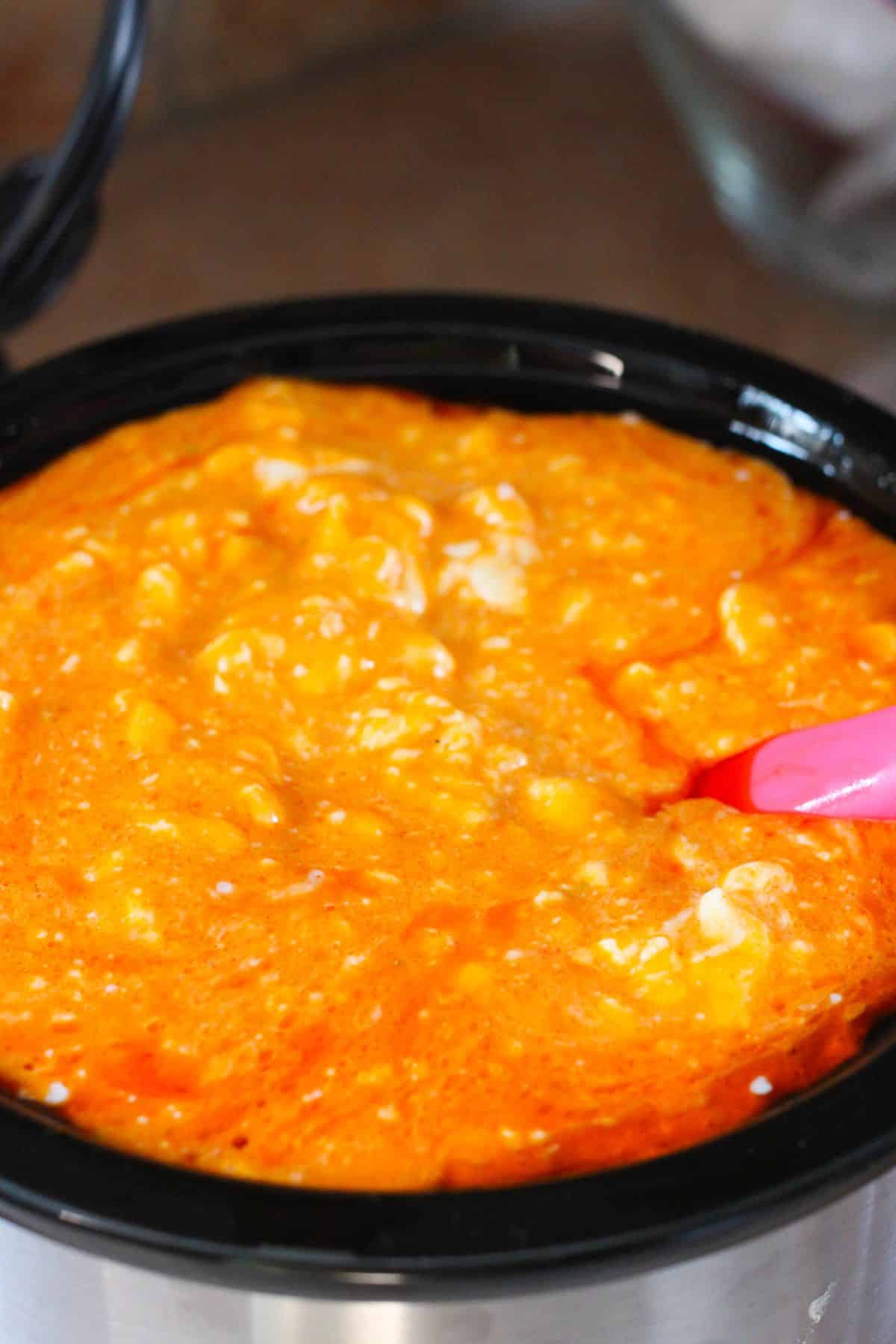 buffalo chicken dip being cooked in the slow cooker.