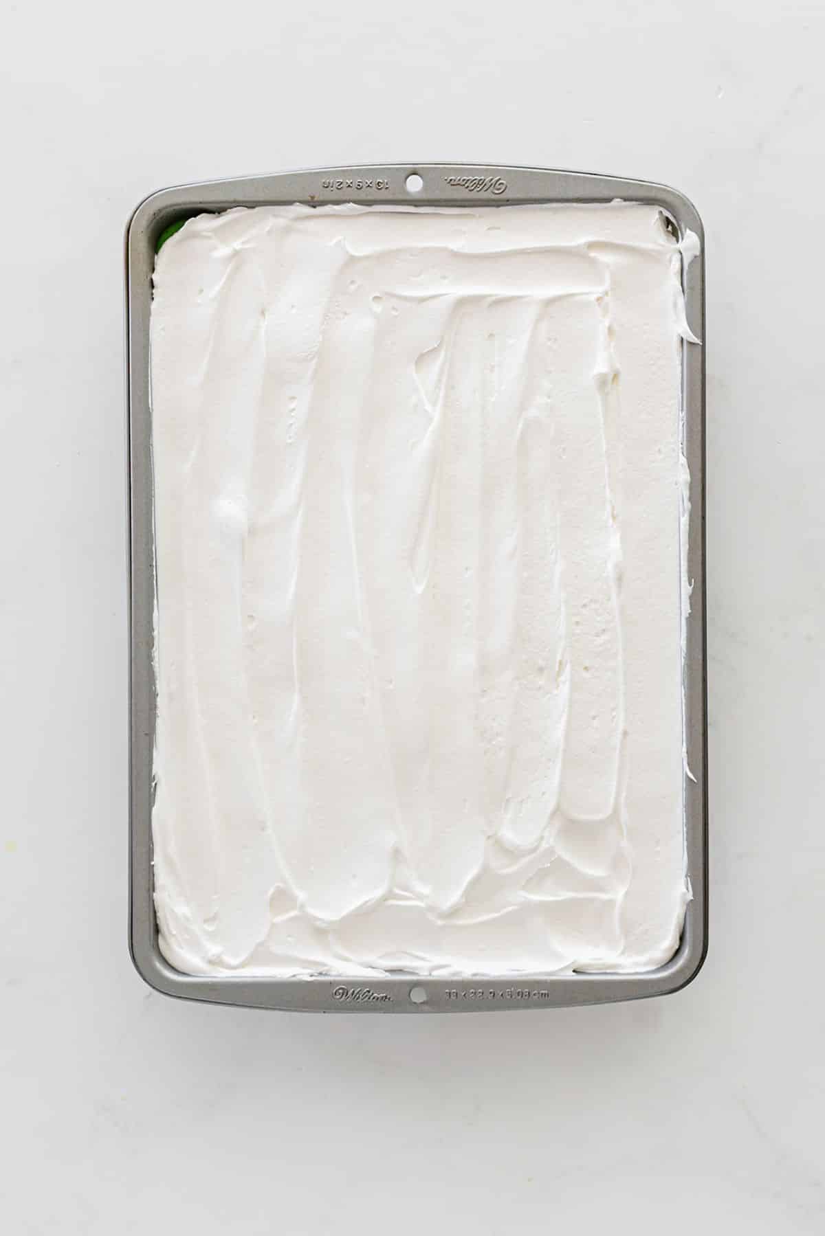 The remaining Cool Whip spread on top in the pan.