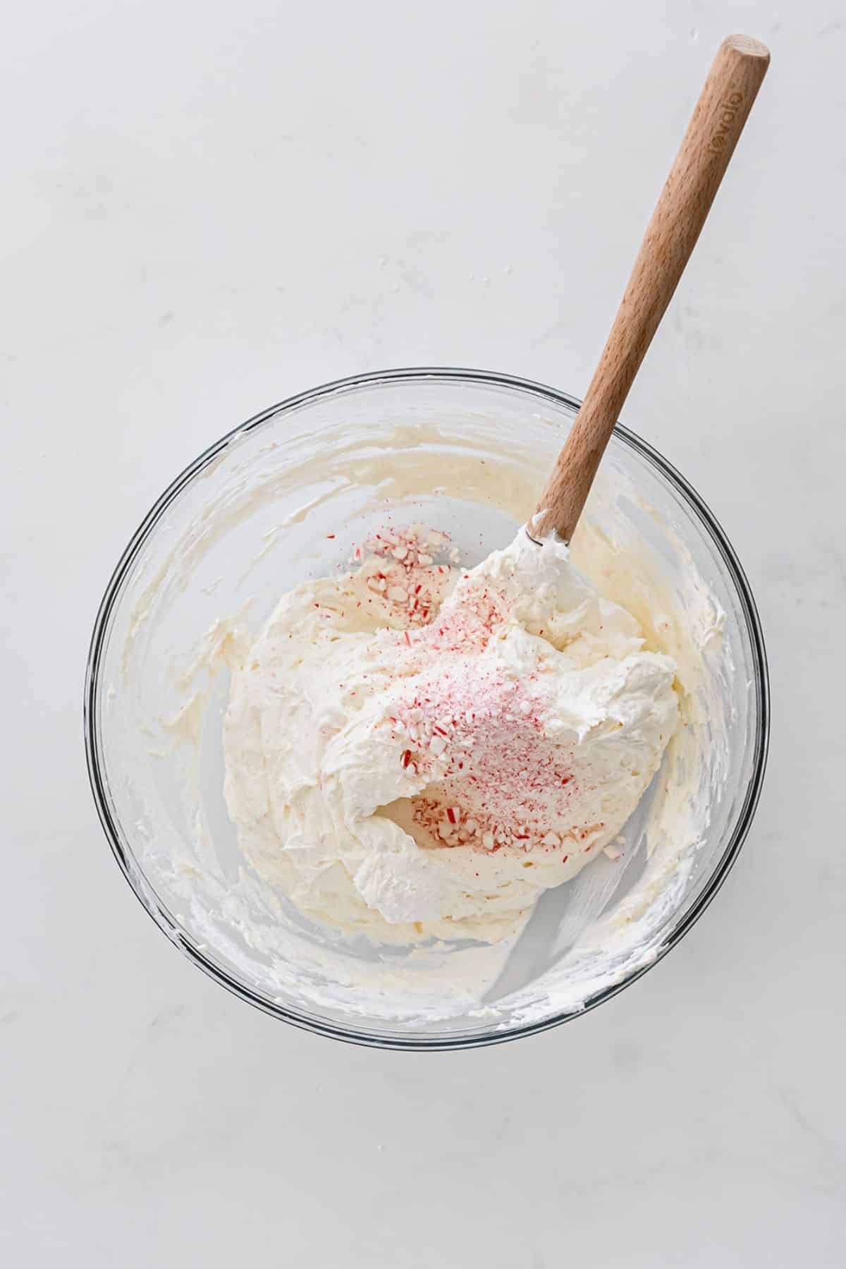 Mix together half of the Cool Whip and crushed candy canes.