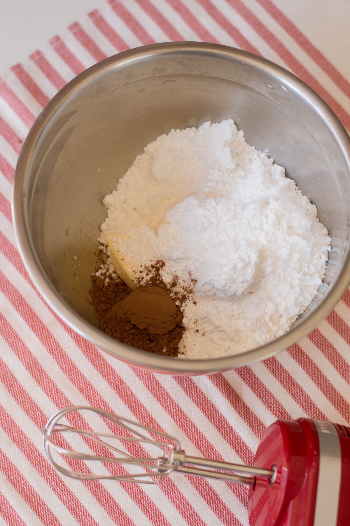 butter, confectioners’ sugar, cocoa powder, and milk in a large mixing bowl.