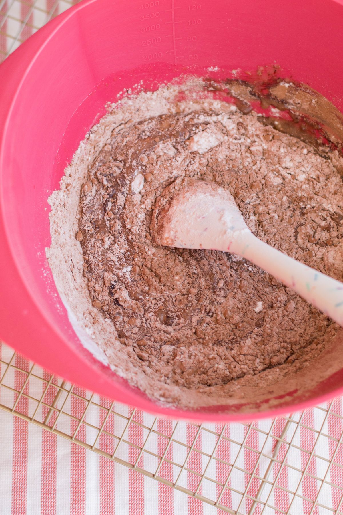 The flour, cocoa powder, baking soda, and salt are added to the wet ingredients.