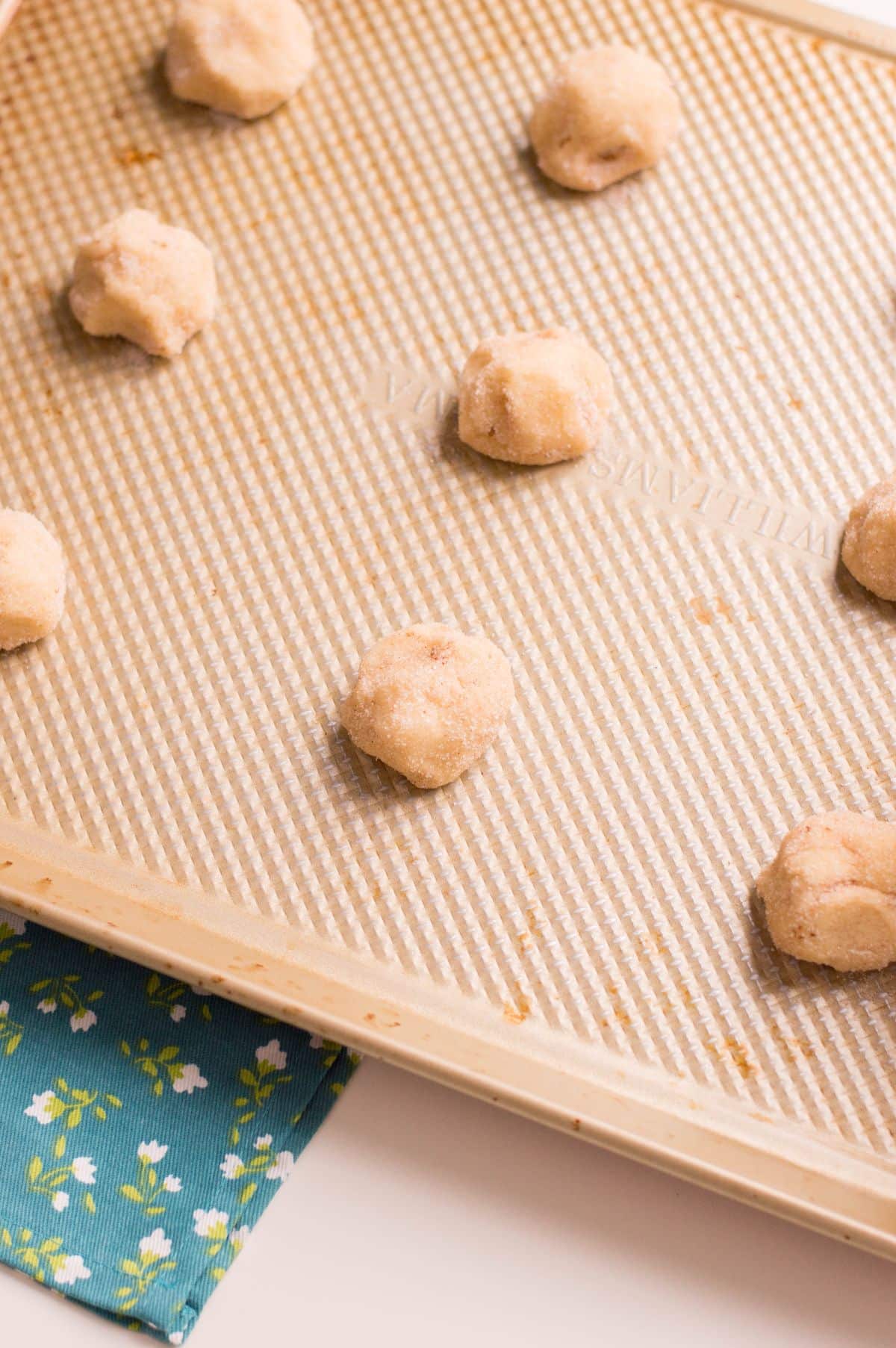 mounds of Cookie dough on the baking sheet.