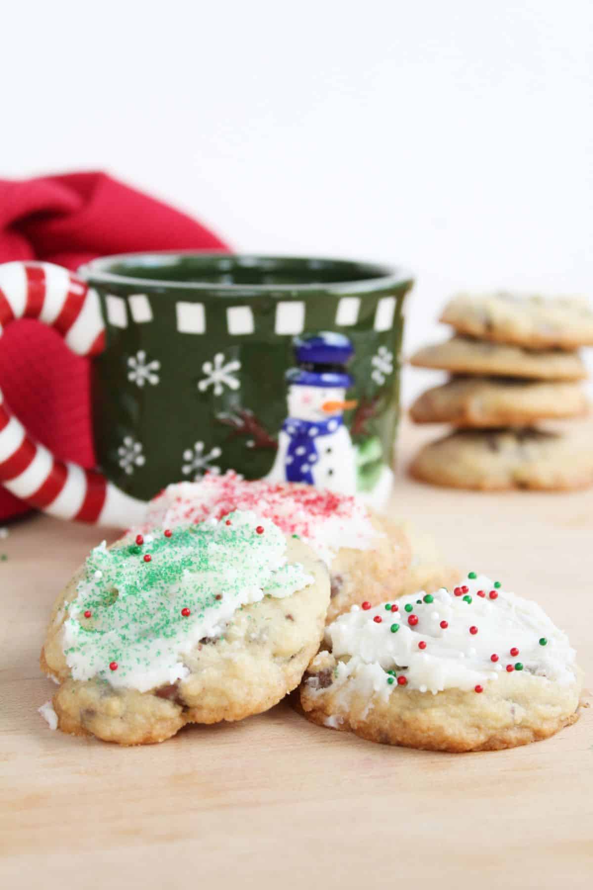 Peppermint Chocolate Chip Cookies with a Christmas mug on the side.