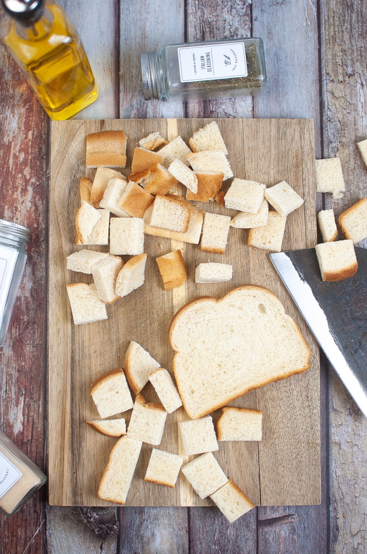 Sliced and cubed bread on a cutting board.