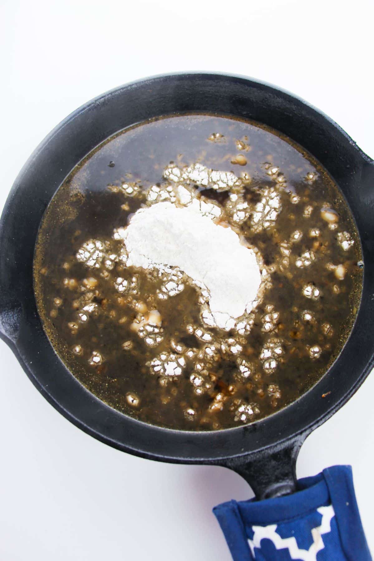 Beef broth and flour in a skillet.