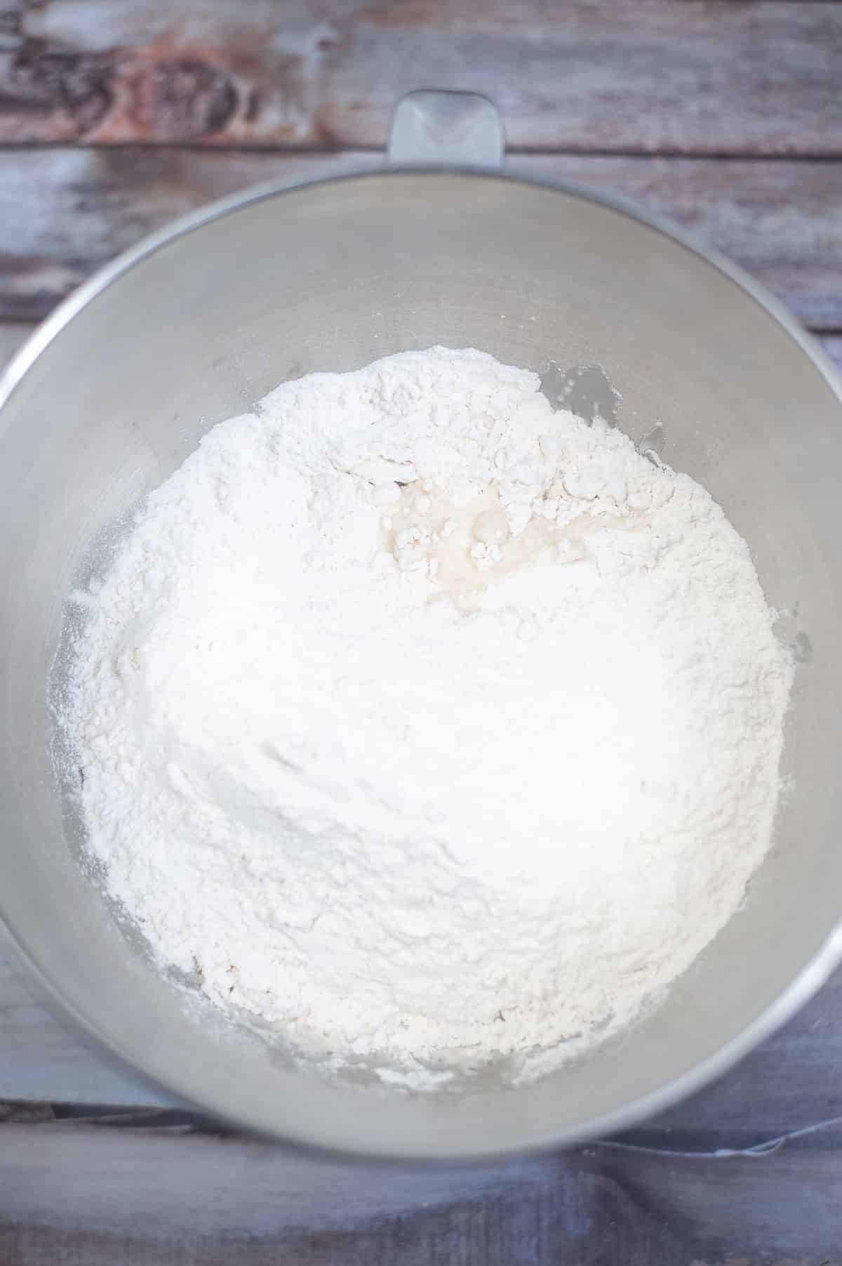 Yeast mixture, salt and flour in a mixing bowl.
