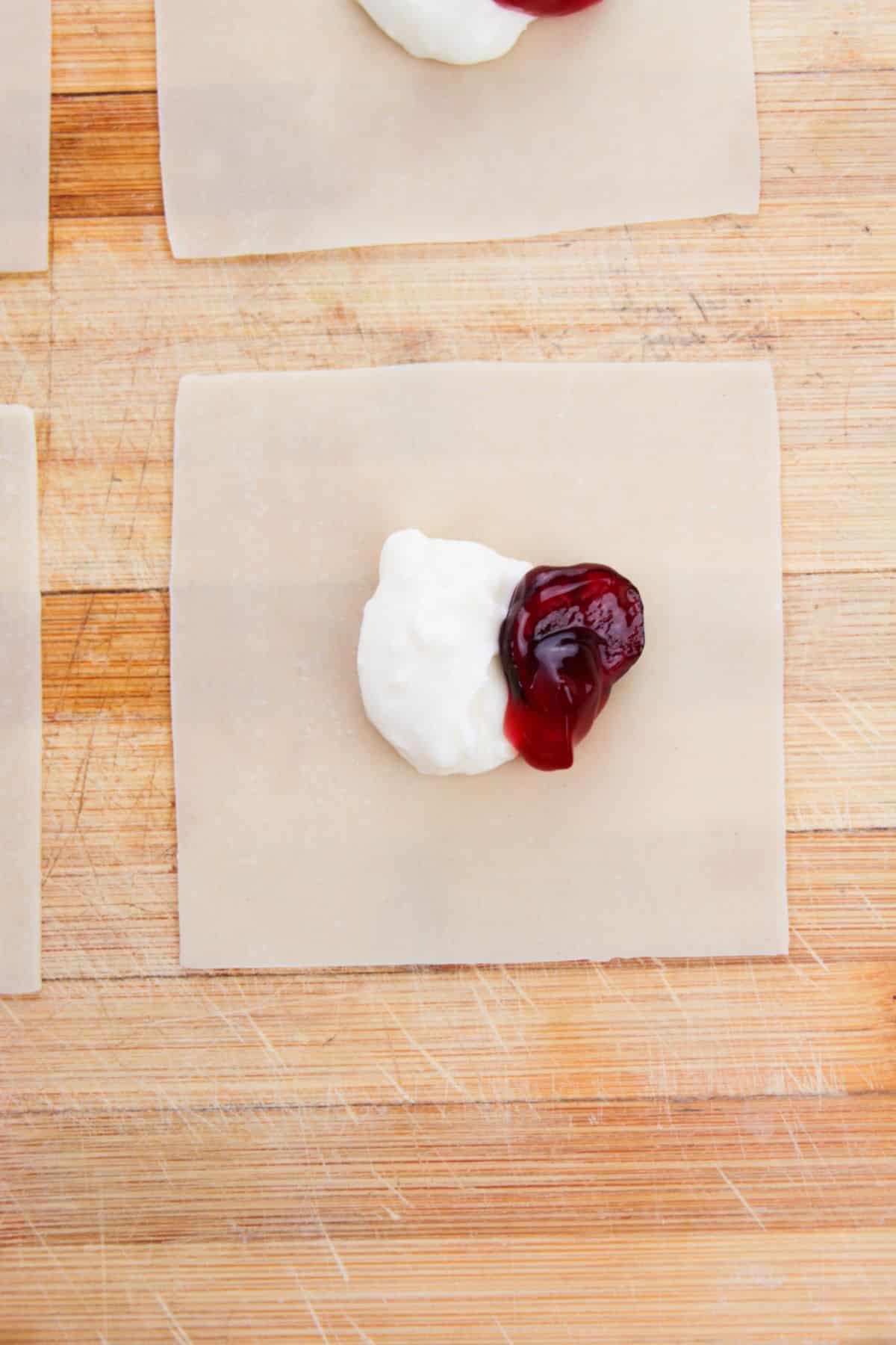 cream cheese mixture and  cherry pie filling on the center of a wonton wrapper.
