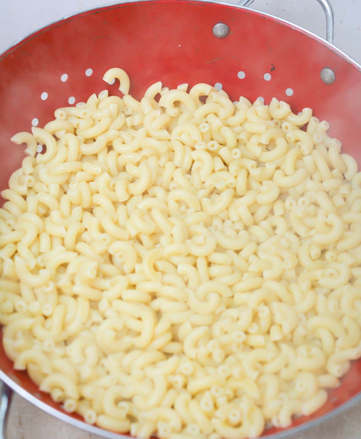 cooked macaroni noodles in a pot.