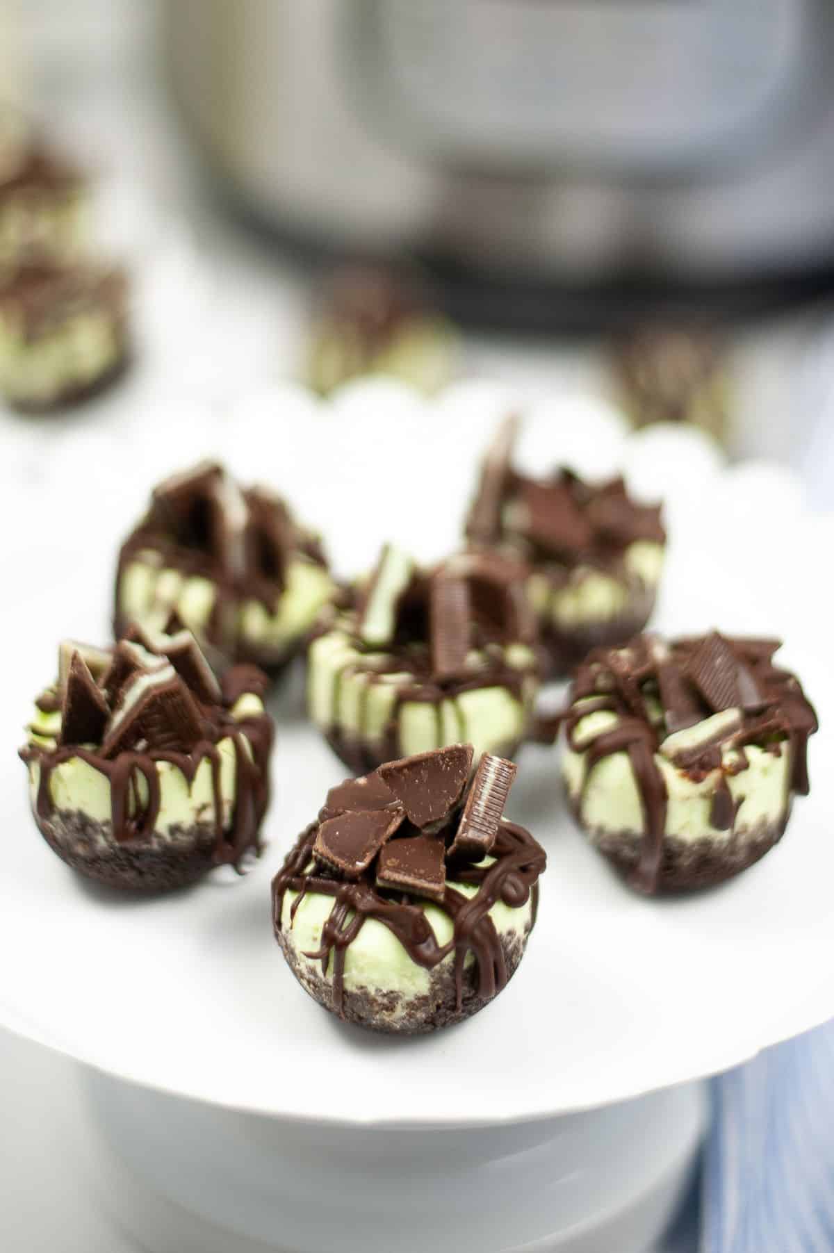 Andes Mint Cheesecake Bites on a serving plate with instant pot on the side.
