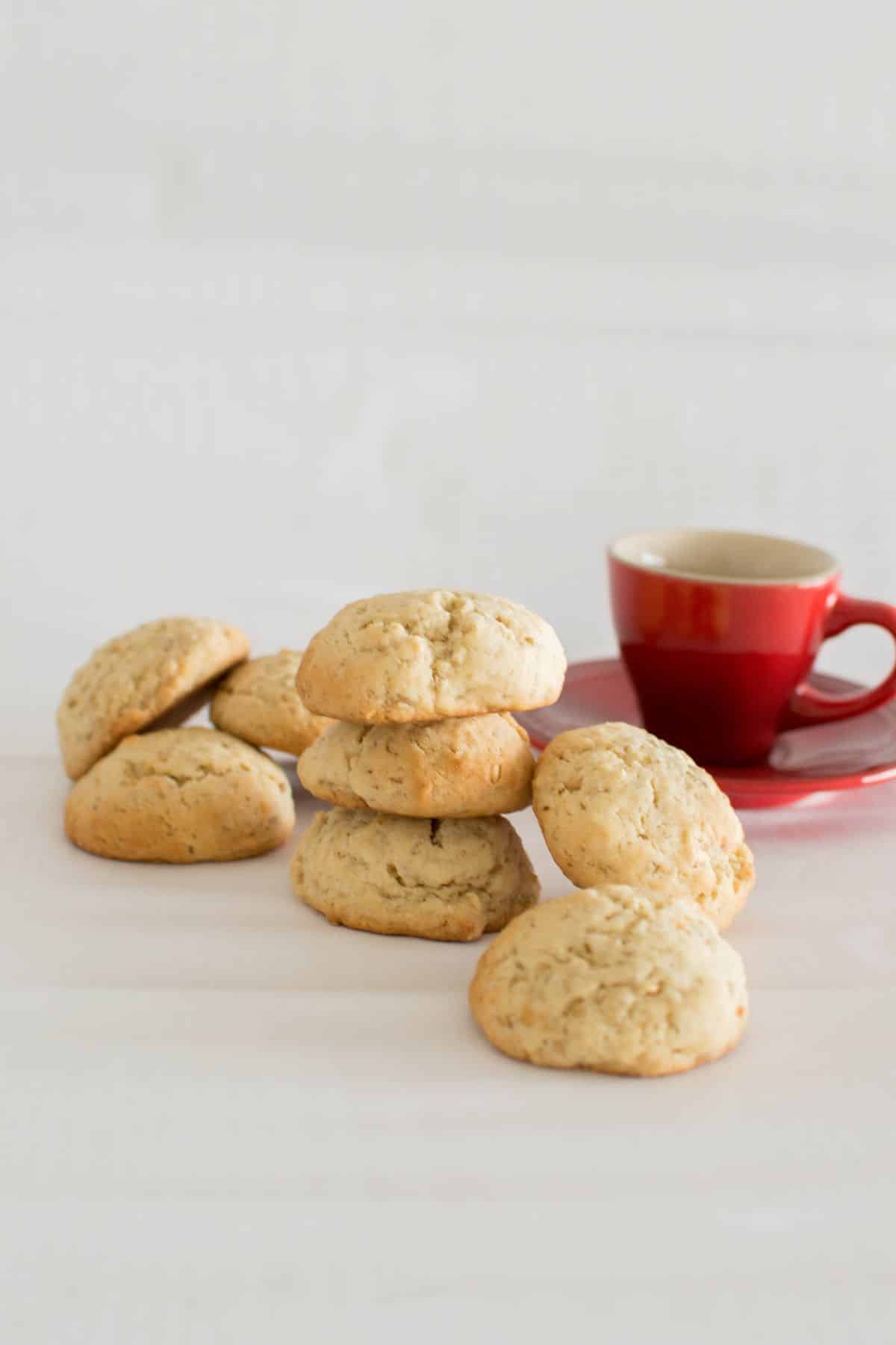 Irish Oatmeal Cookies with a red cup of coffee on the side.