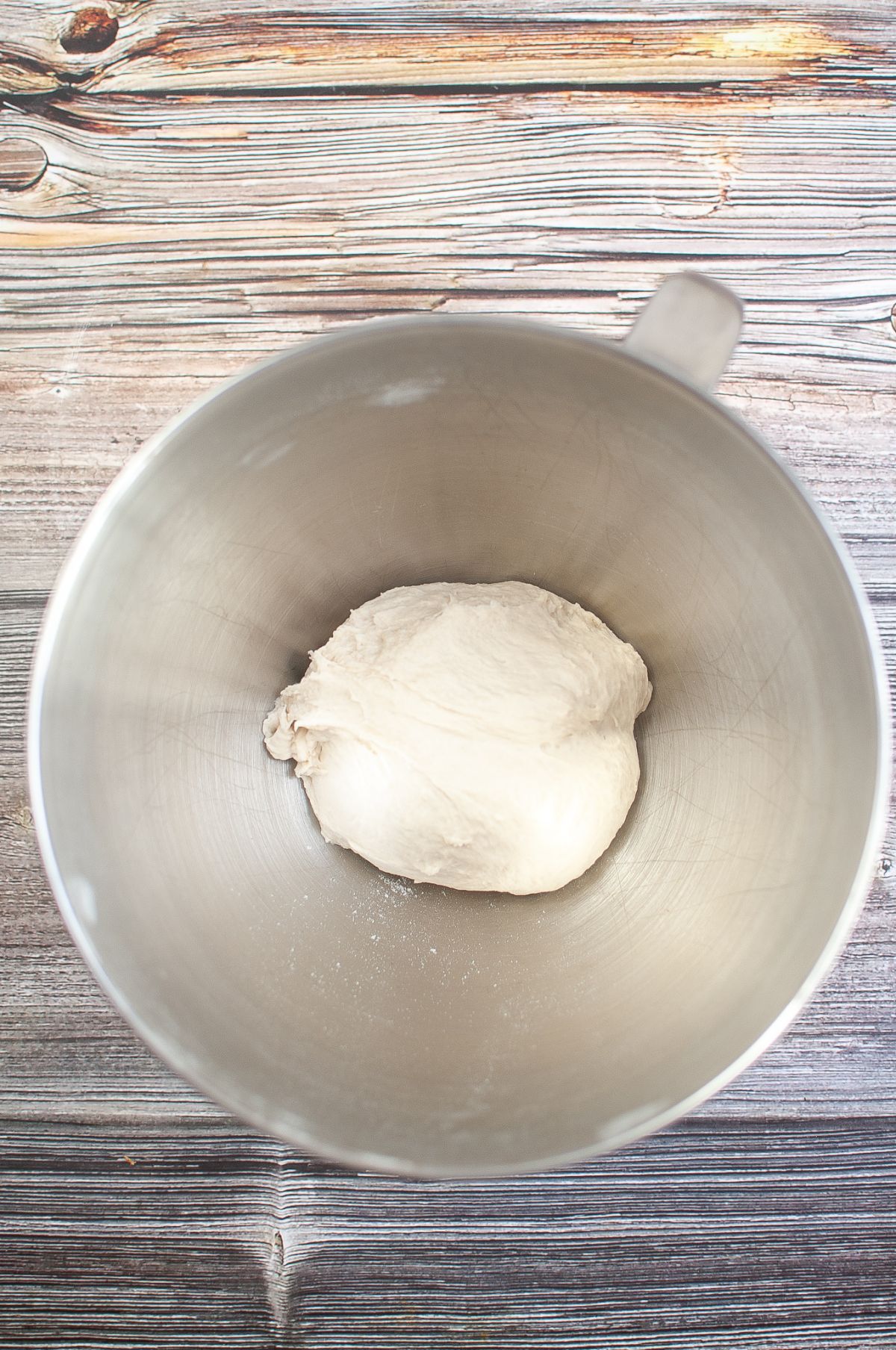Dough in a bowl of stand mixer.