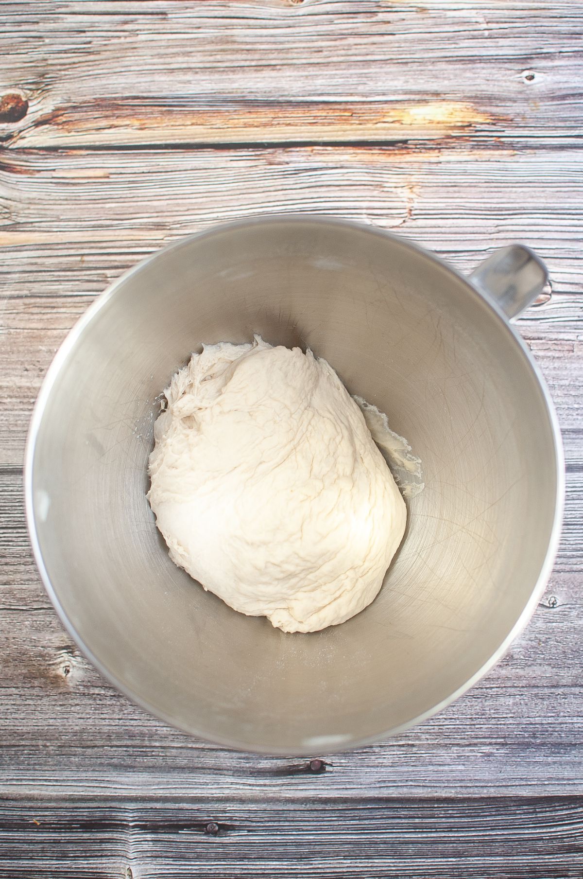 Doubled size dough in a mixing bowl.