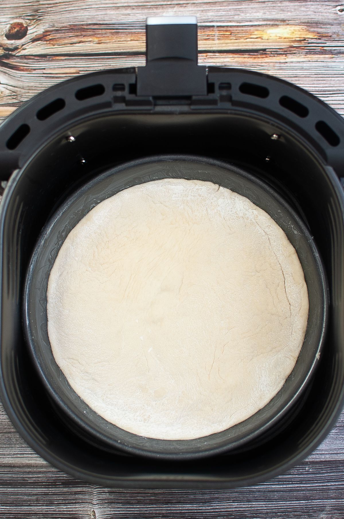Pan with dough inside the Air Fryer.