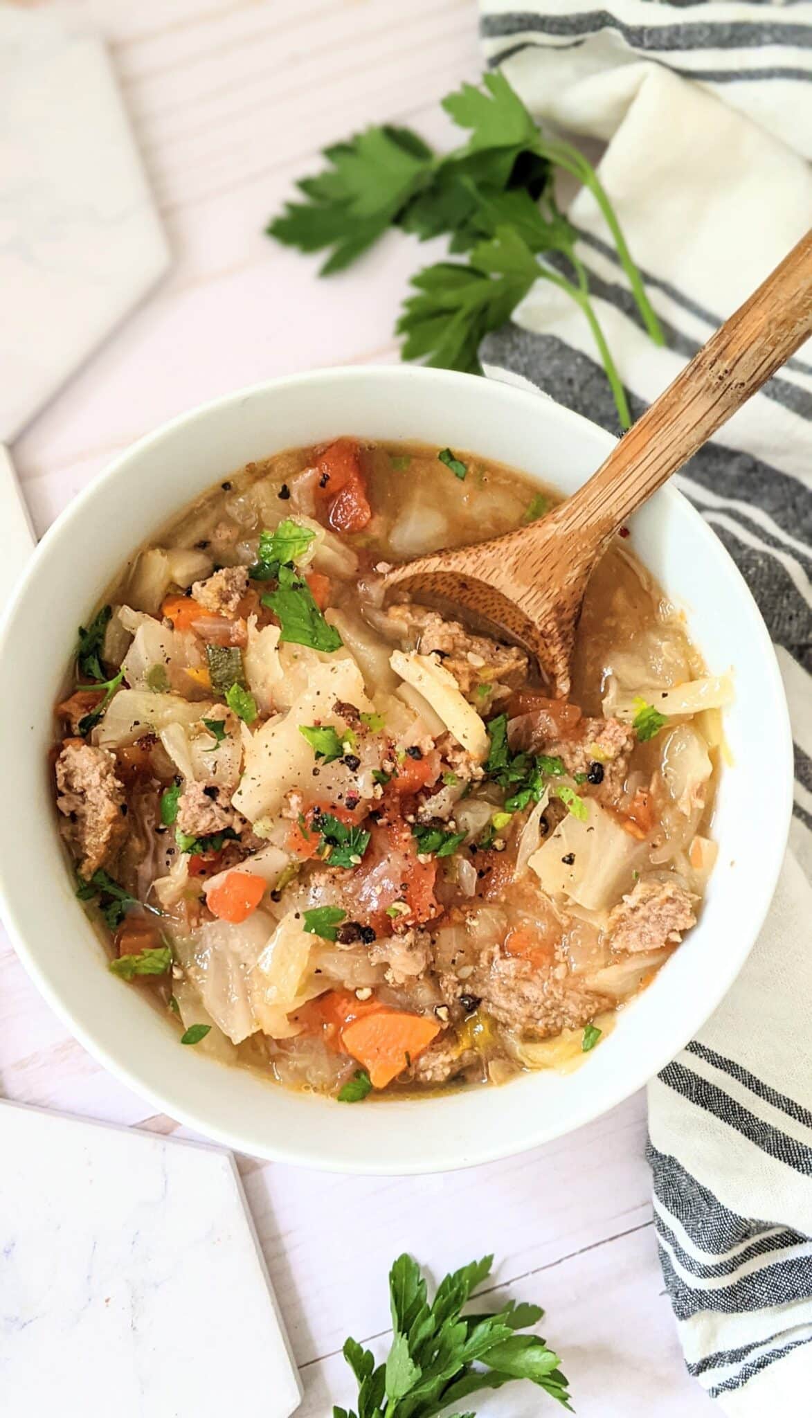 Instant Pot Turkey Cabbage Soup in a serving bowl with wooden spoon in it.  