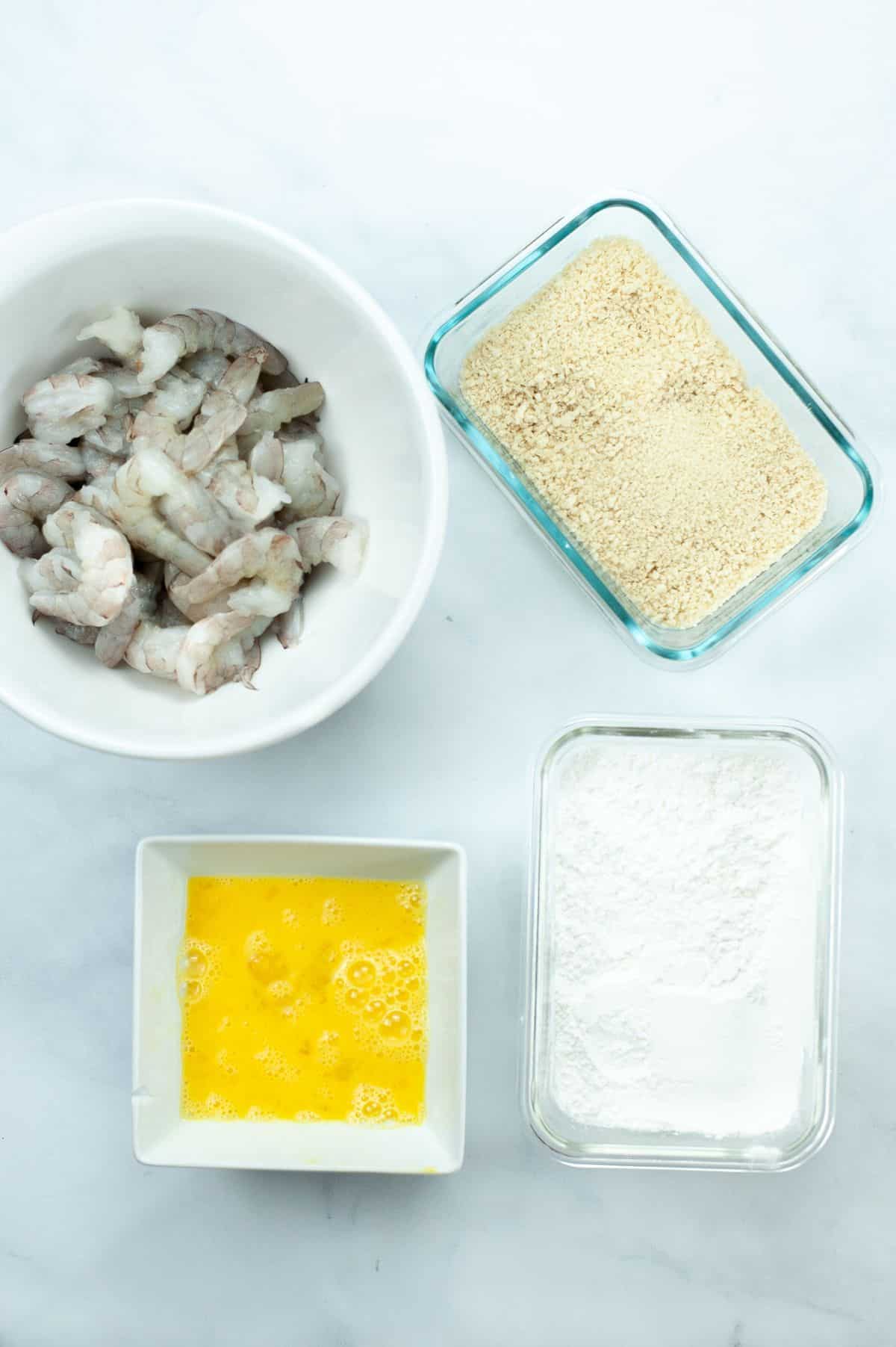 shrimp, cornstarch, panko and eggs in dishes