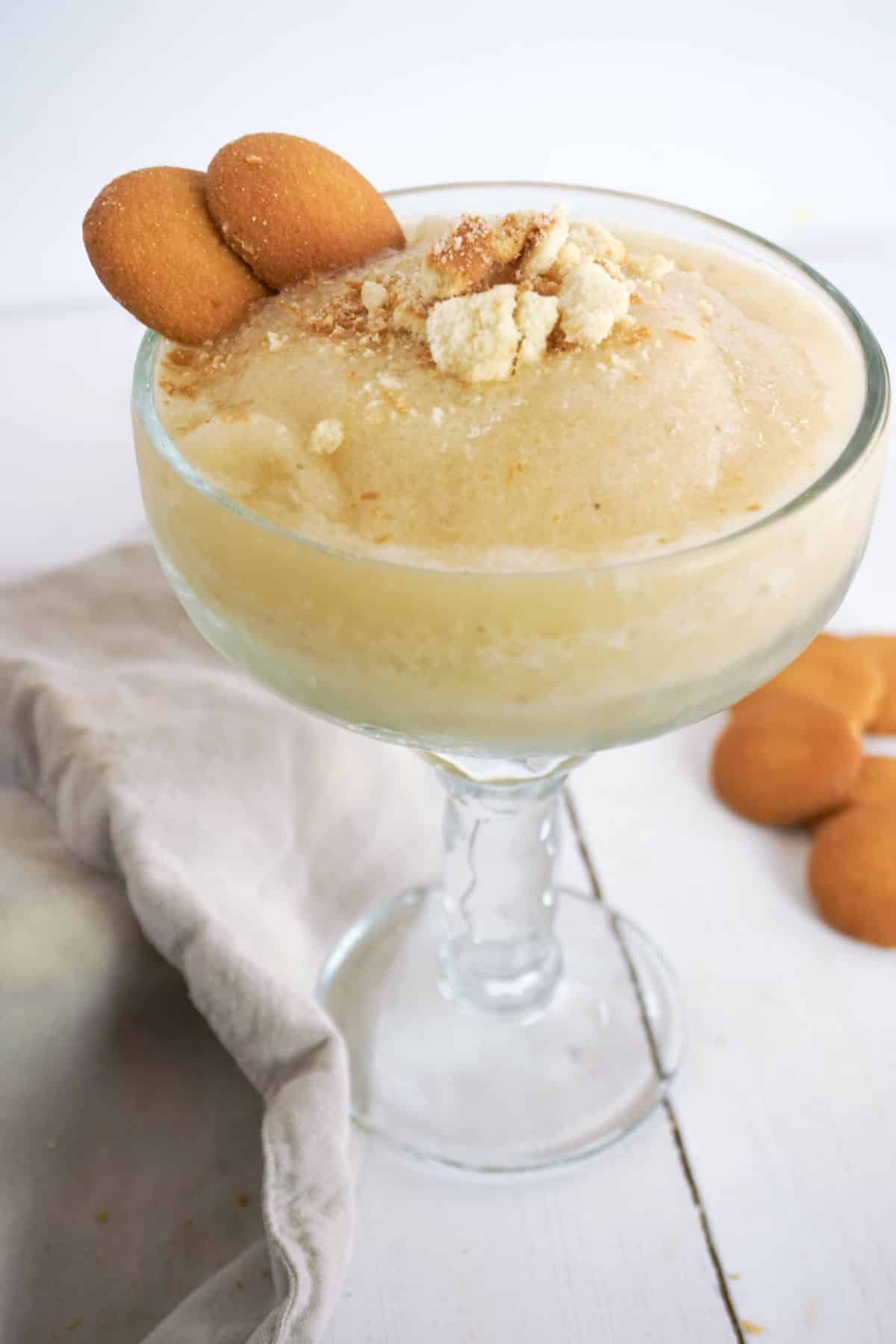 Banana Margarita in a serving glass, garnished with Nilla Wafers.