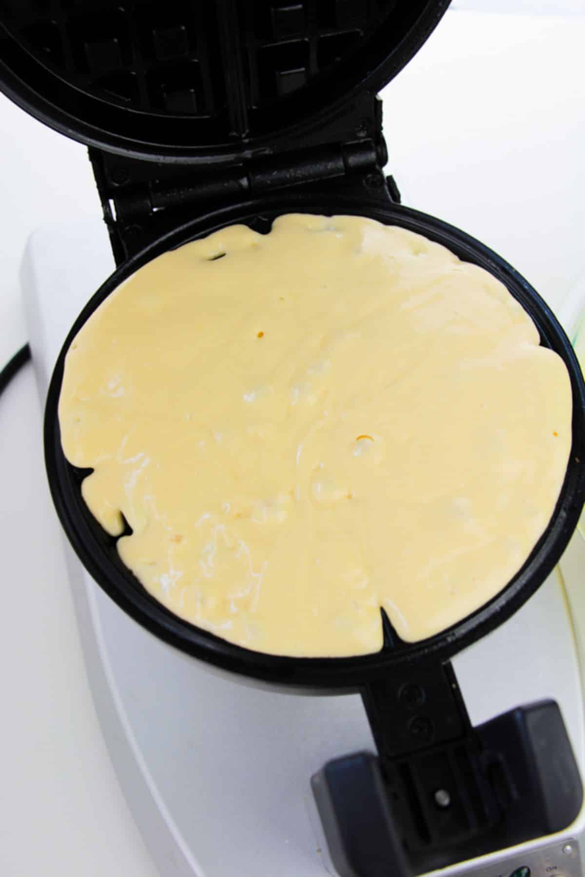 batter in the waffle iron plate.