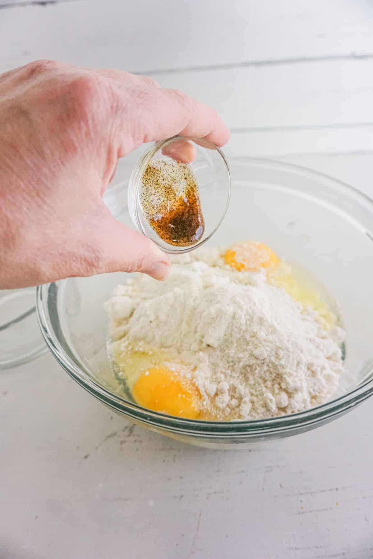 In a large mixing bowl, vanilla extract is added to cake mix with egg.