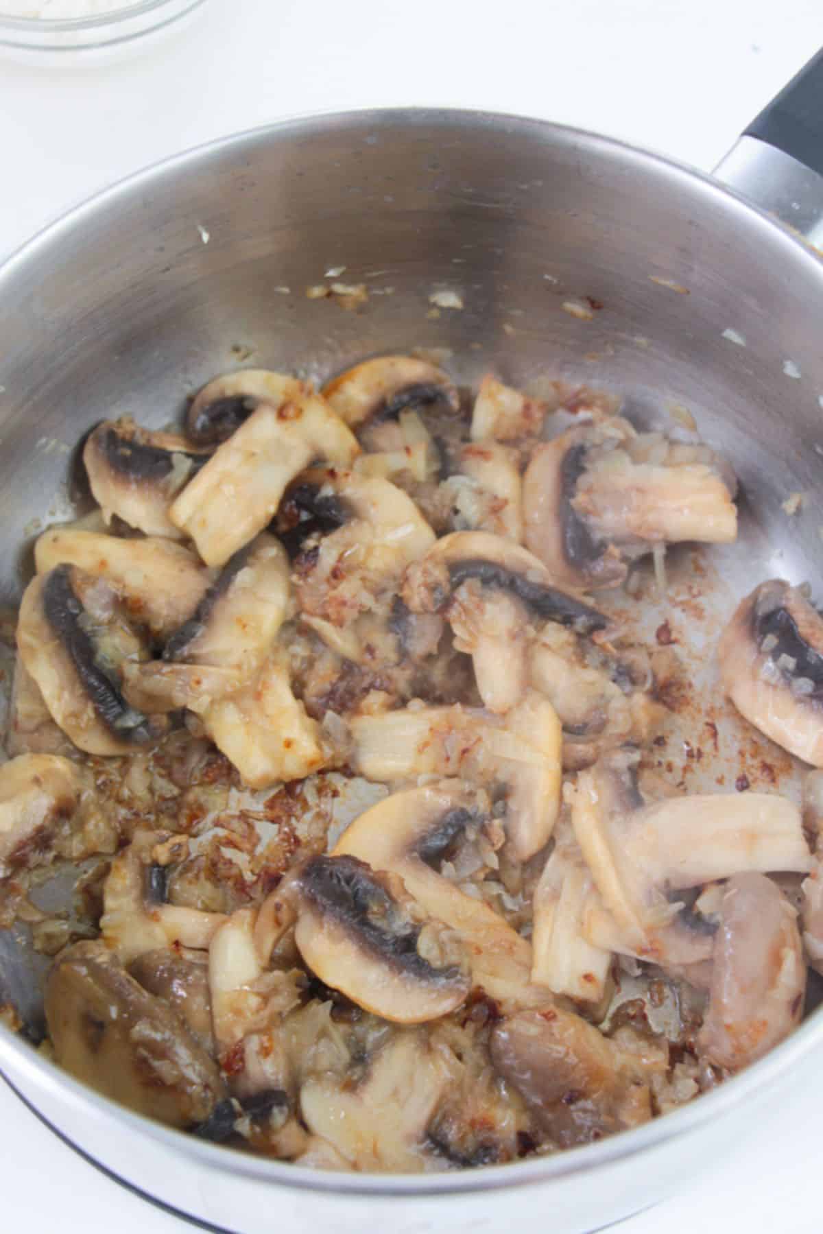 Mushrooms are added to the large pot.