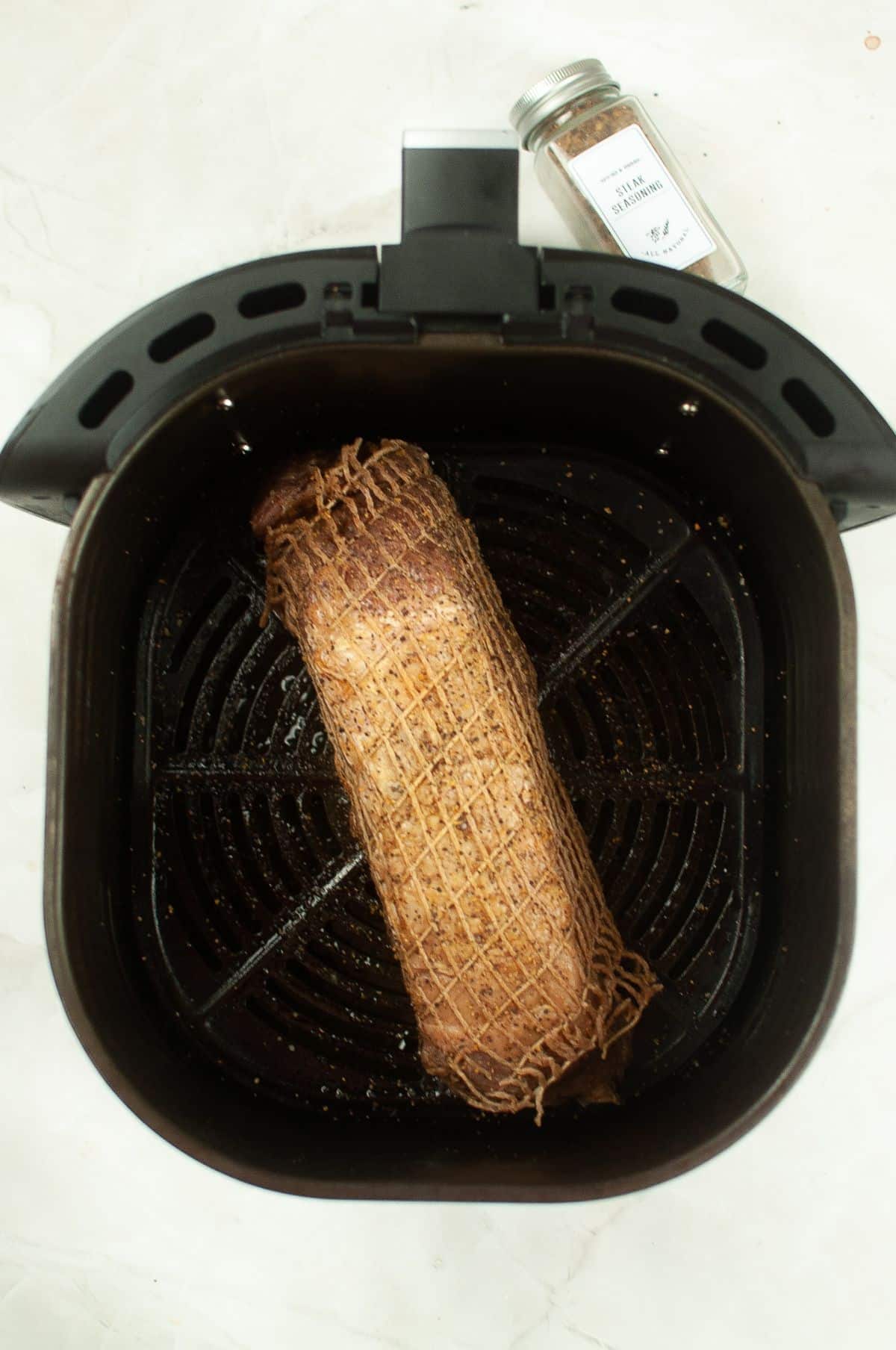 beef loin inside the Air Fryer basket.