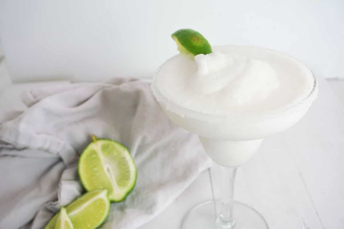 Coconut Lime Margarita in a serving glass, garnished with lime.