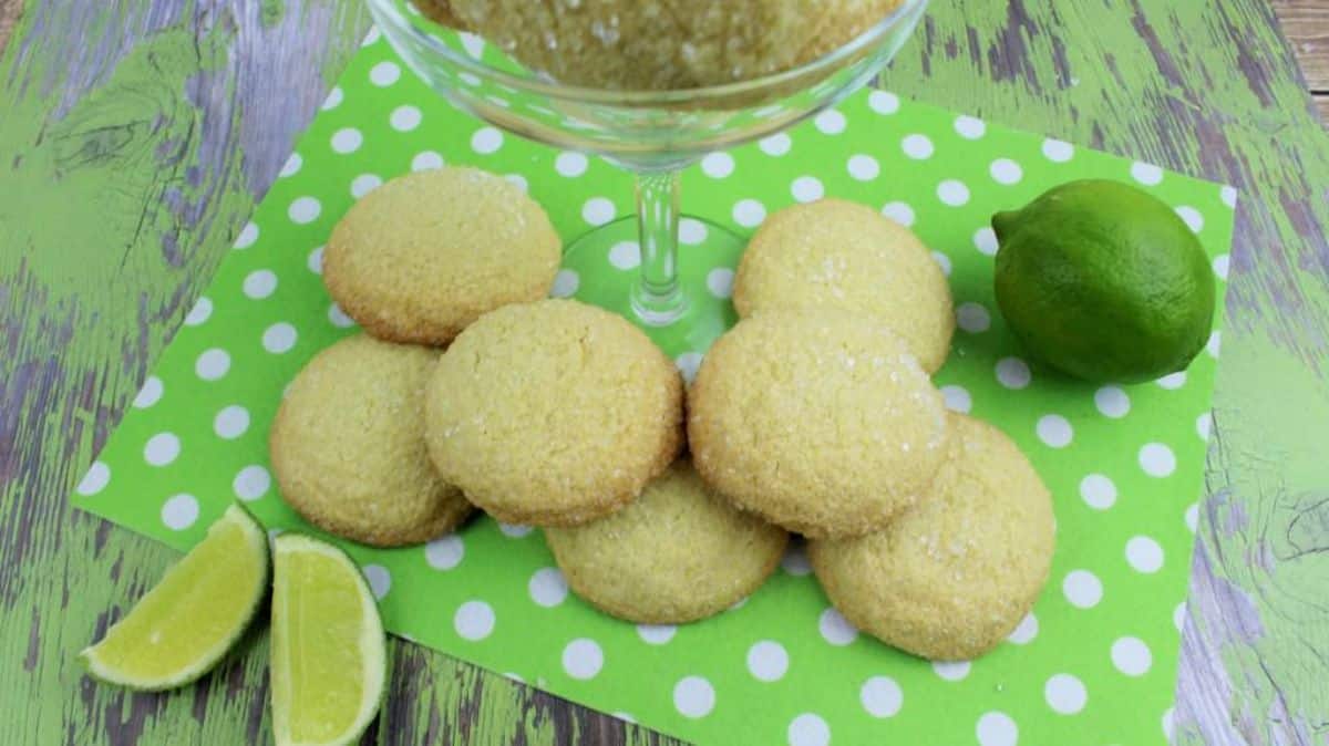 Margarita Cookies on polka dots green cloth with lime and margarita glass with cookies on the side.