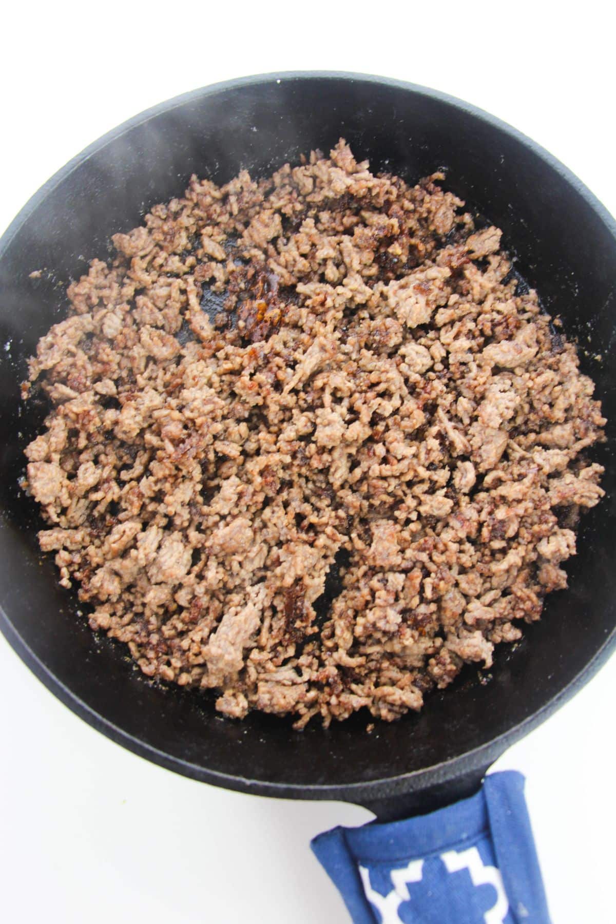 Cooked ground beef in skillet.