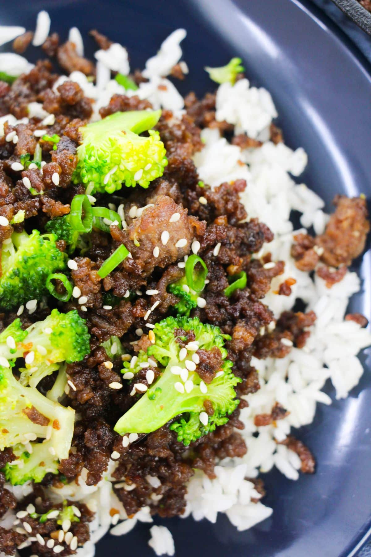 A close-up look of Korean Ground Beef and Broccoli on a serving plate, garnished with sesame seeds.