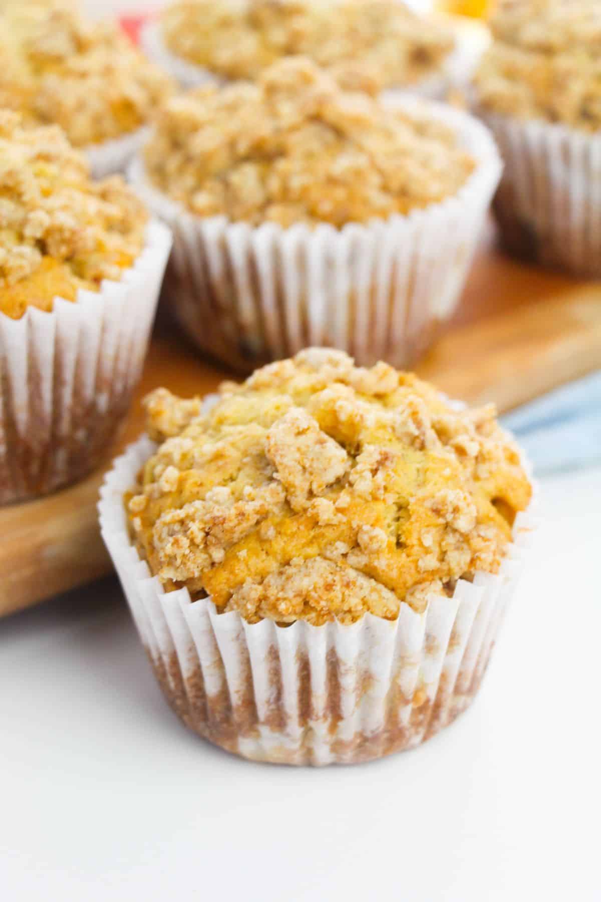 Apple Crumble Muffins on a wooden board.