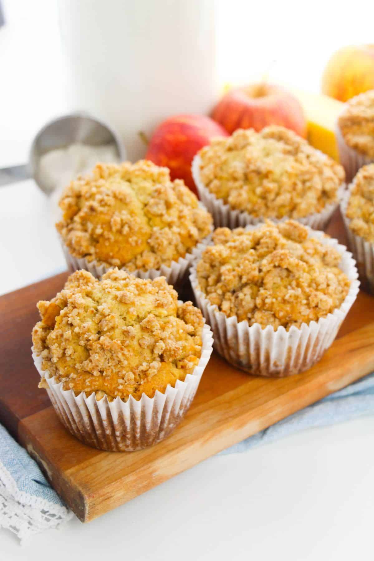Apple Crumble Muffins on a wooden board.